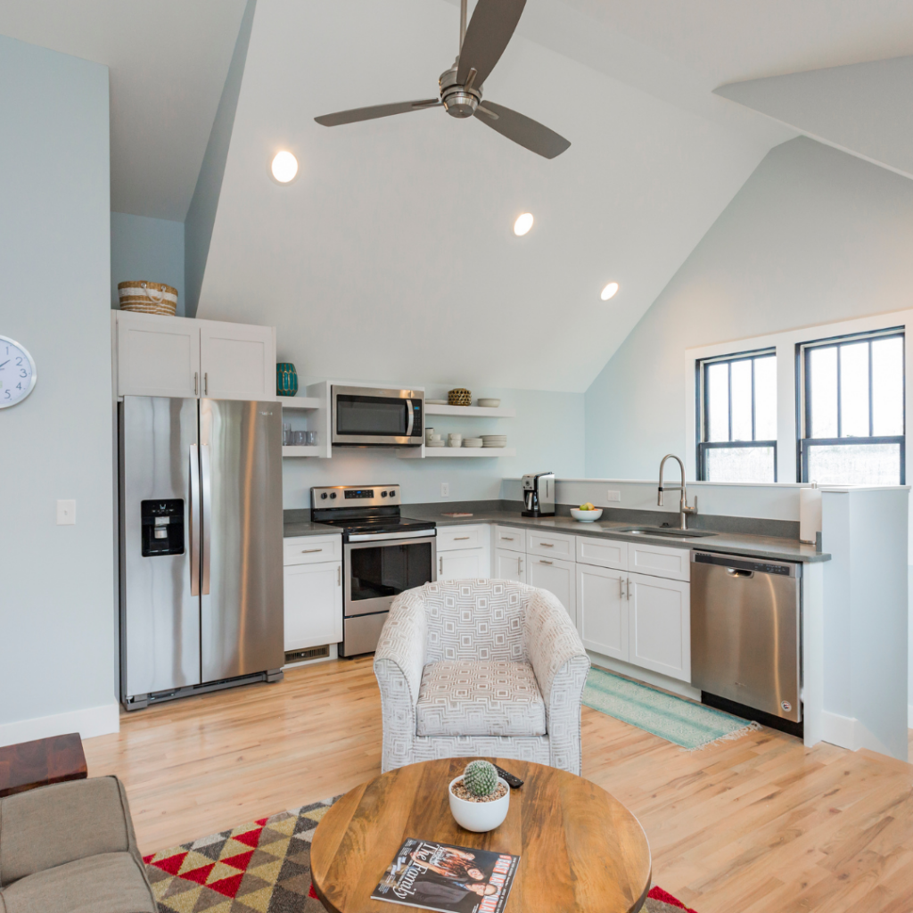 Open-concept DADU interior with vaulted ceilings, modern kitchen, and cozy living area.