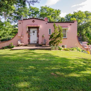 Restored historic Spanish-style home with stucco exterior and terracotta roof.