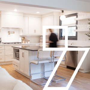 Modern white kitchen with island and chrome barstools in a custom-built Nashville home by BuildCo7